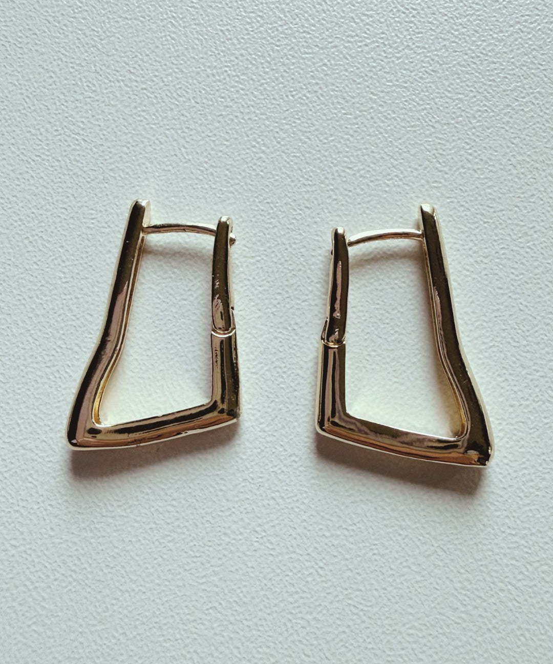 Gold-plated sculpted huggie hoop earrings with modern angular design