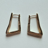 Gold-plated sculpted huggie hoop earrings with modern angular design